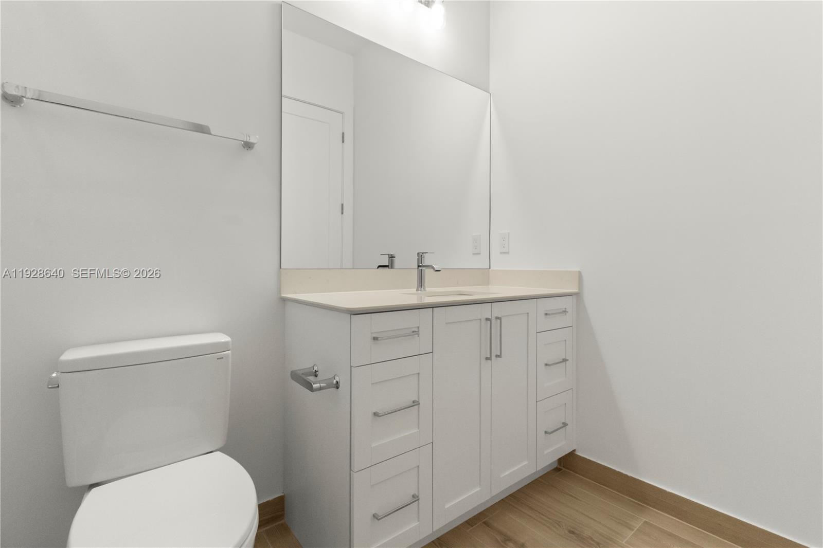 1419 Southwest 23rd Street Fort Lauderdale, FL 33315 - Photo 11 of 17 a bathroom with a toilet sink vanity and mirror