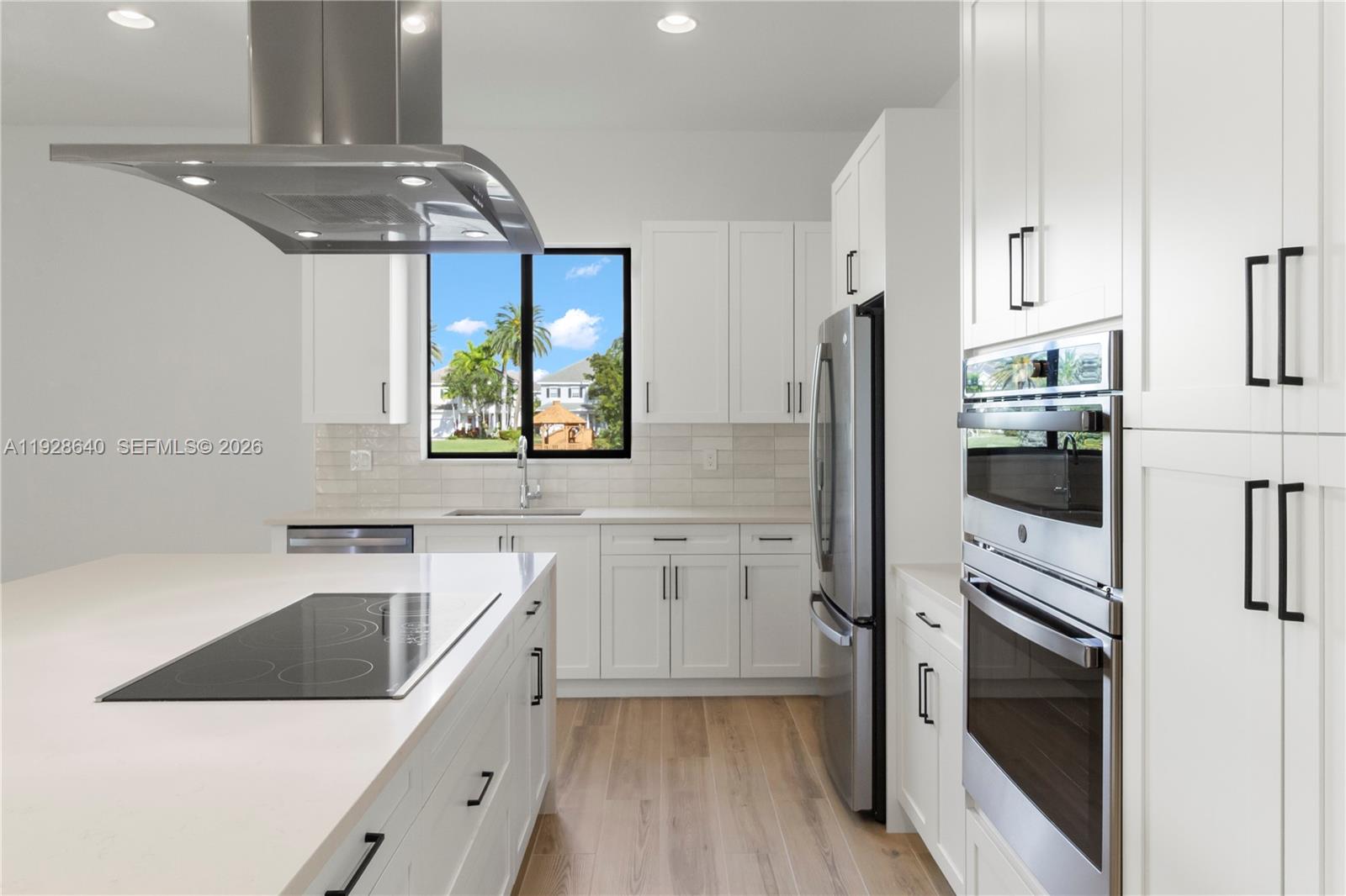 1419 Southwest 23rd Street Fort Lauderdale, FL 33315 - Photo 8 of 17 a kitchen with a sink a refrigerator and window