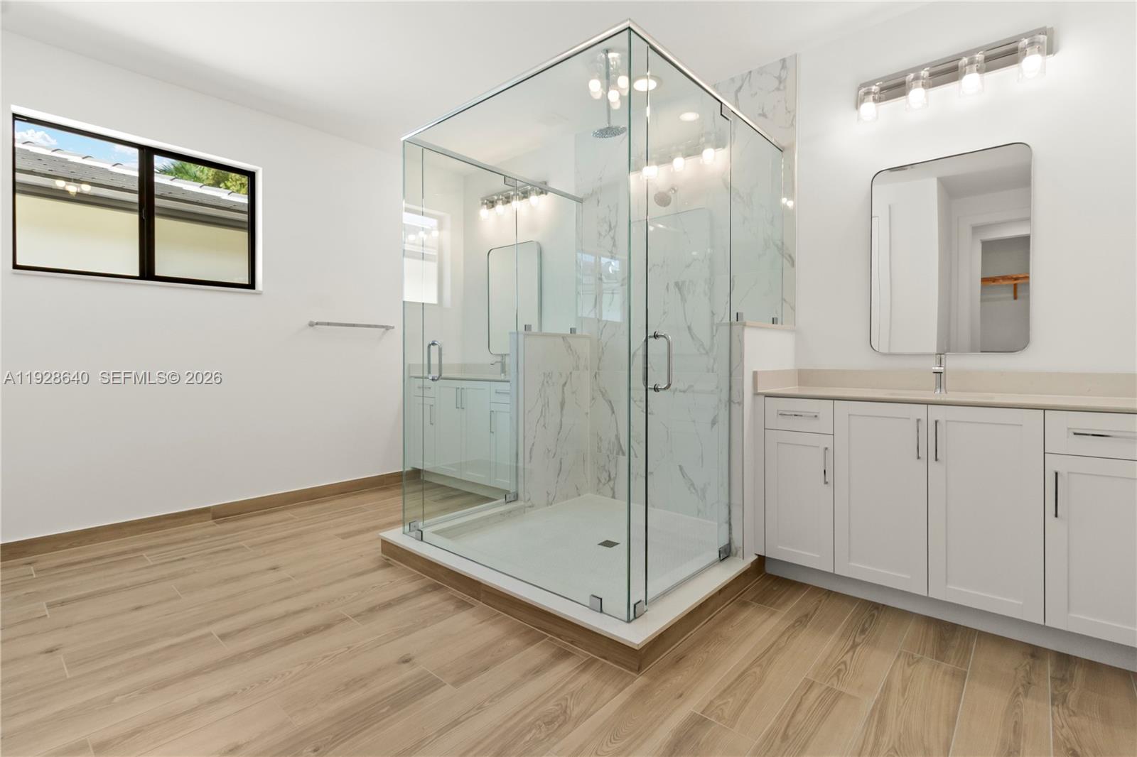 1419 Southwest 23rd Street Fort Lauderdale, FL 33315 - Photo 9 of 17 a bathroom with a glass shower door and a glass door