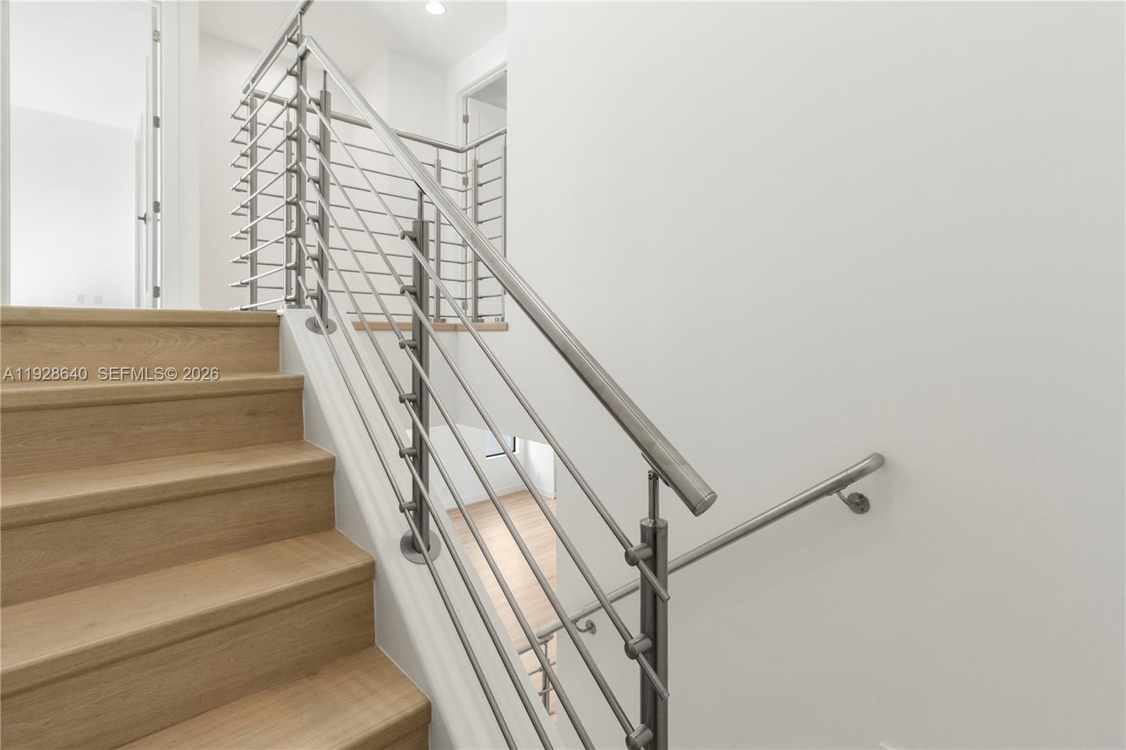 1419 Southwest 23rd Street Fort Lauderdale, FL 33315 - Photo 10 of 17 a view of staircase with white walls and railing