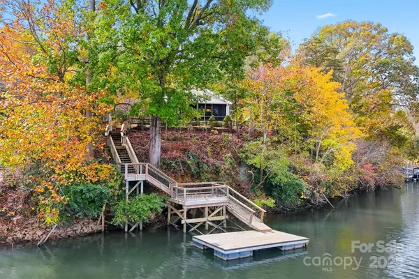 a view of a house with a yard from a lake view