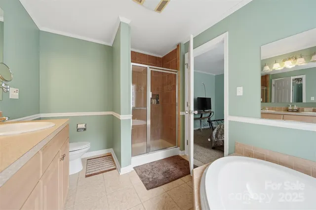 a spacious bathroom with a tub sink and mirror