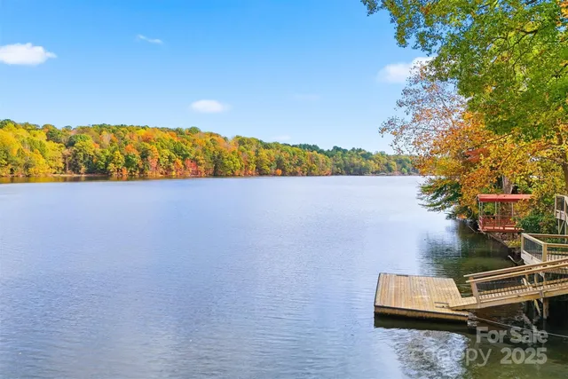 an aerial view of lake and residential houses with outdoor space