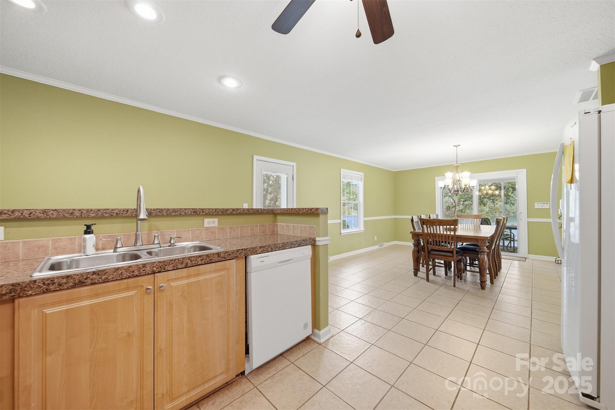 4247 Laurel Hill Road Claremont, NC 28610 - Photo 10 of 34 a kitchen with kitchen island granite countertop a sink a stove a dining table and chairs