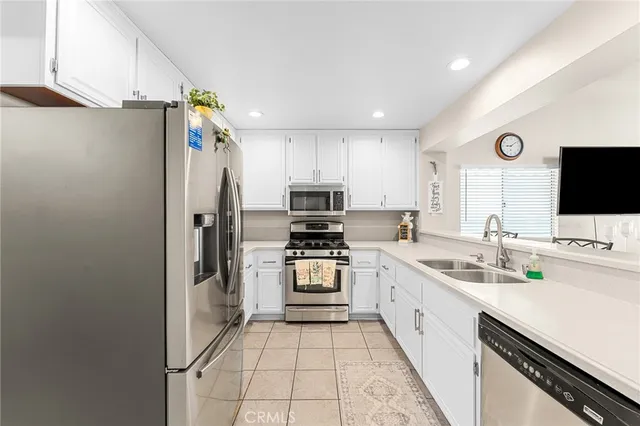 a kitchen with a sink appliances and cabinets