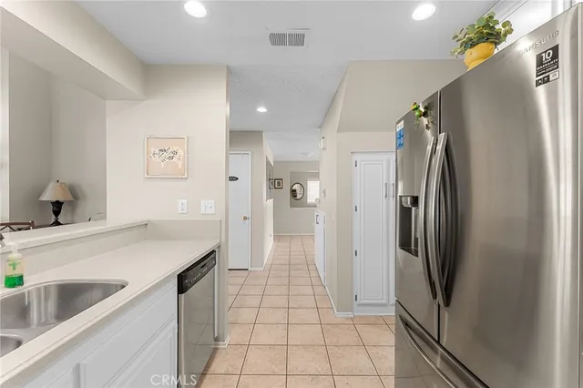 a kitchen with stainless steel appliances a refrigerator and a sink