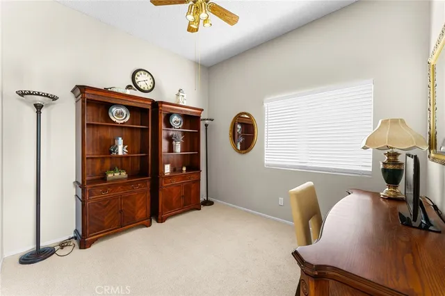 a view of a workspace with furniture and a window
