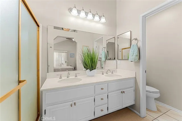 a bathroom with a double vanity sink and a mirror