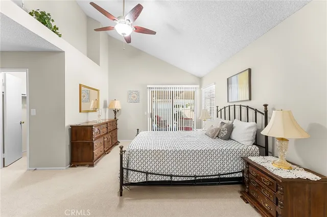 a bedroom with a bed and dresser with mirror