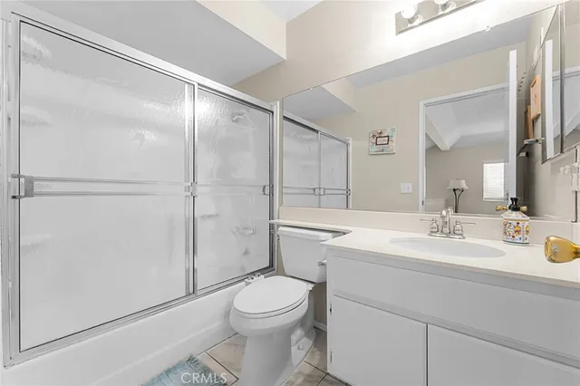 a bathroom with a sink mirror vanity and toilet