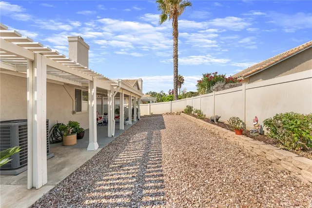 a view of a street with wooden fence