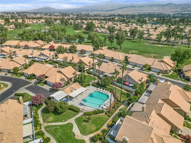an aerial view of residential houses with outdoor space and river