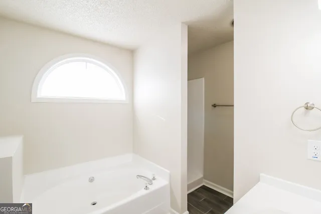 a bathroom with a bathtub and a shower