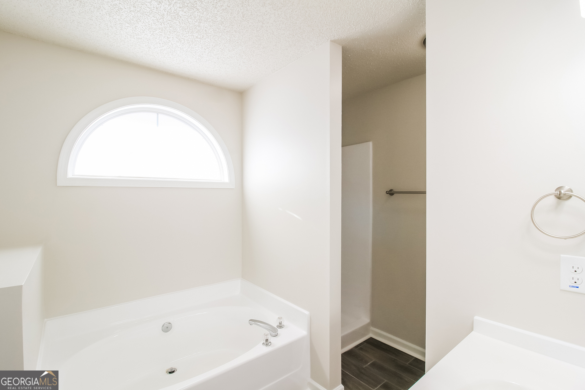 10381 Commons Crossing Jonesboro, GA 30238 - Photo 11 of 17 a bathroom with a bathtub and a shower