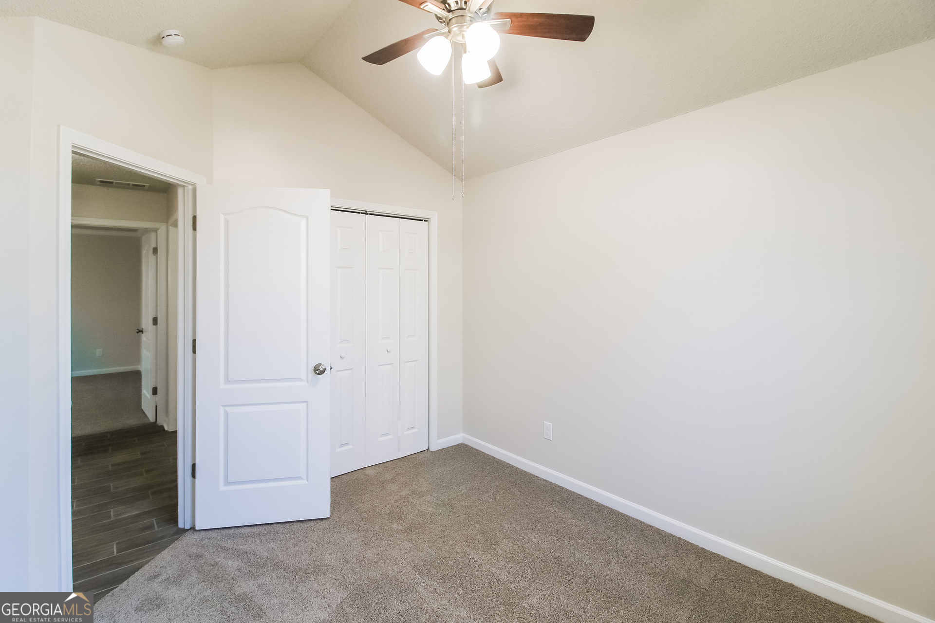 10381 Commons Crossing Jonesboro, GA 30238 - Photo 12 of 17 wooden floor in an empty room