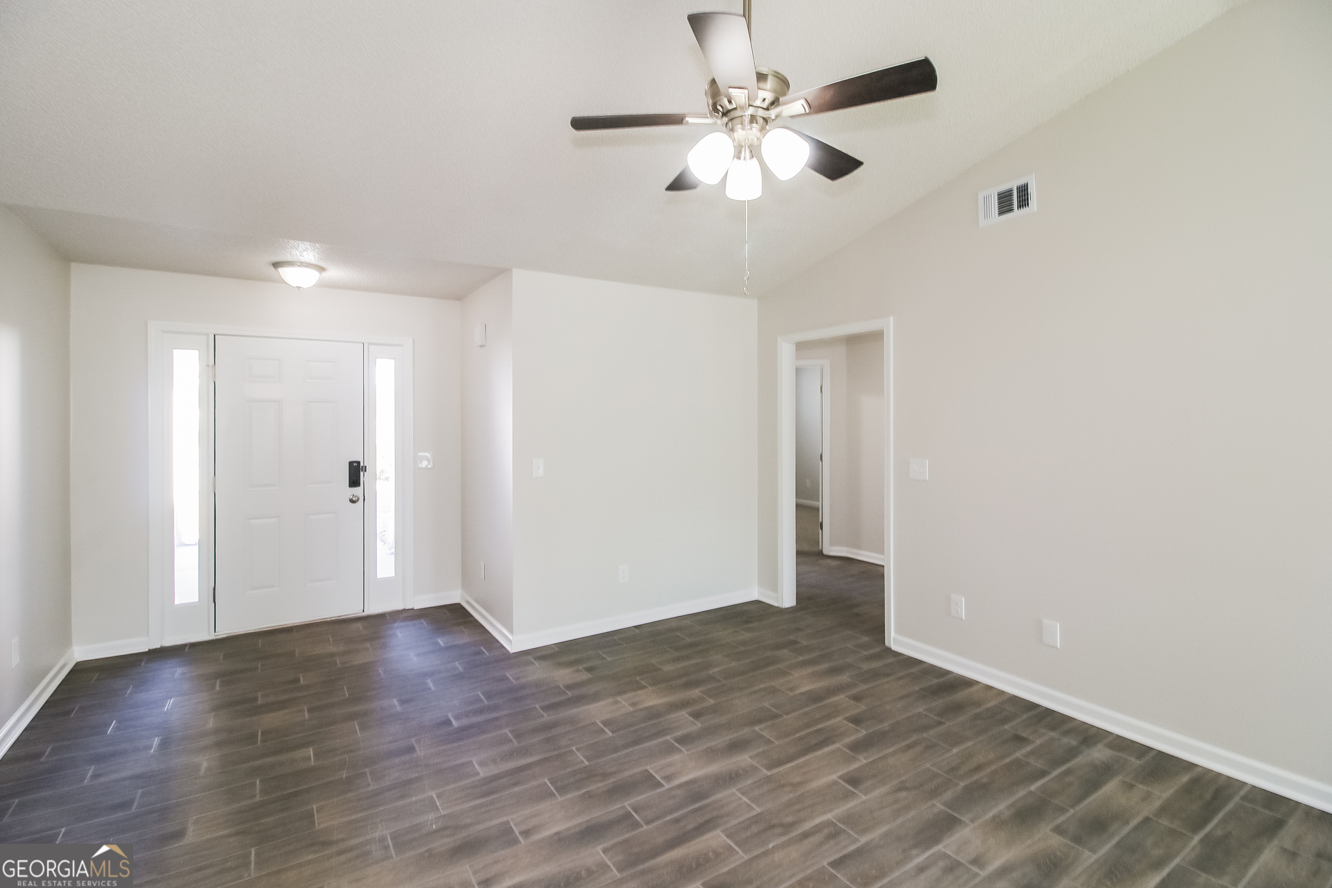 10381 Commons Crossing Jonesboro, GA 30238 - Photo 3 of 17 a view of an empty room with wooden floor