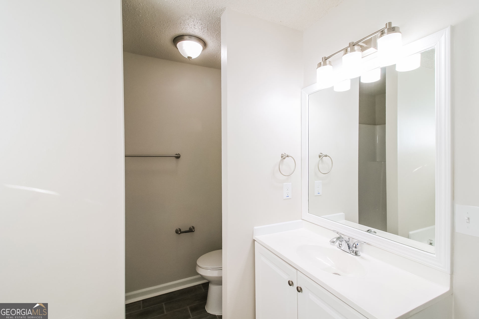 10381 Commons Crossing Jonesboro, GA 30238 - Photo 10 of 17 a bathroom with a sink a toilet and shower