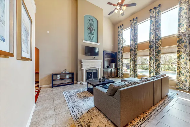a living room with furniture large window and a fireplace