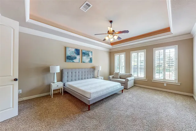 a bedroom with a bed couch and window