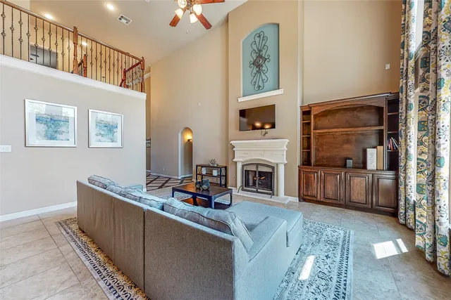 a living room with furniture a flat screen tv and a fireplace