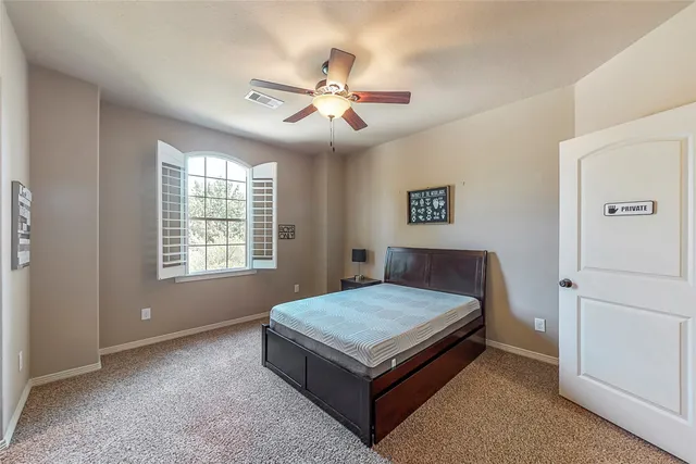 a bed sitting in a room next to a window