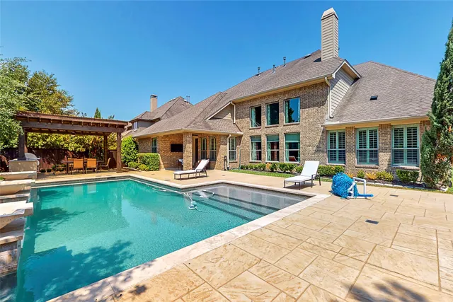 a view of house with swimming pool yard and outdoor seating