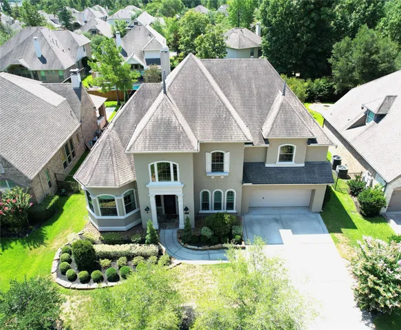a aerial view of a house with yard and green space