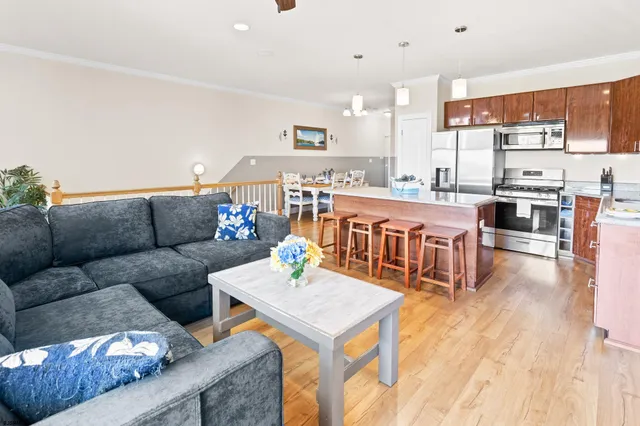 a view of a dining room with furniture and wooden floor