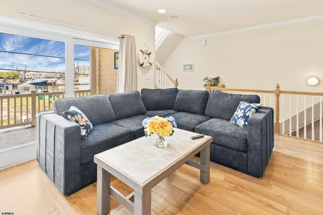 a view of a dining room with furniture a chandelier and wooden floor