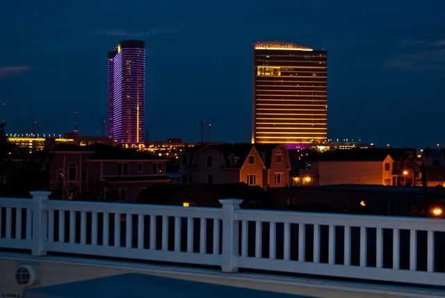 a bathroom with a granite countertop sink mirror and toilet