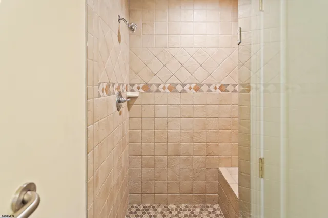 a view of a hallway with wooden floor and front door