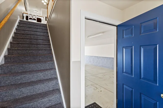 a view of a street with potted plants