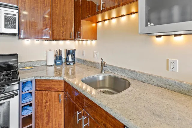 a kitchen with a table chairs refrigerator and cabinets