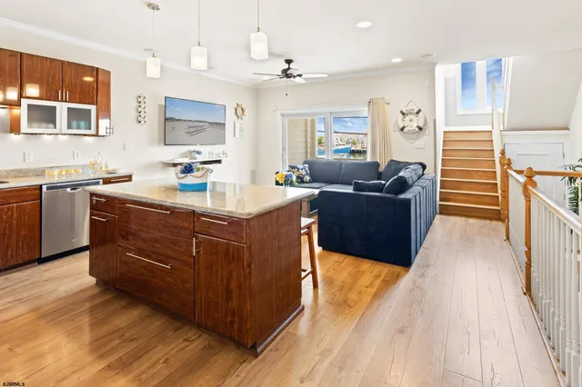 a kitchen with sink a stove and chairs