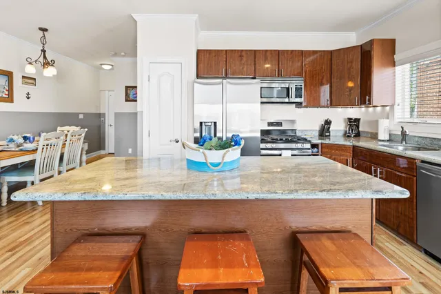 a living room with furniture and a kitchen view