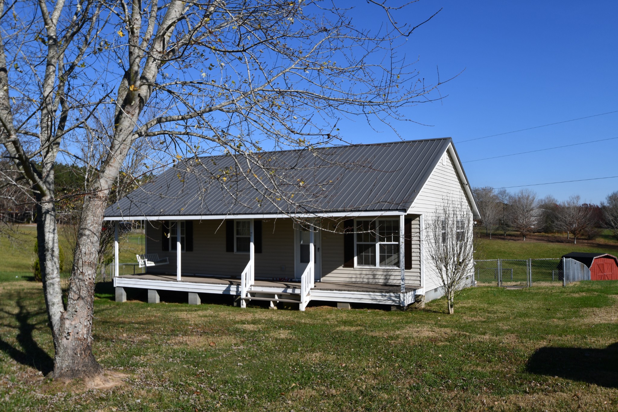 7 Fleeman Road Lawrenceburg, TN 38464 - Photo 2 of 16 a view of a house with a yard porch and wooden fence