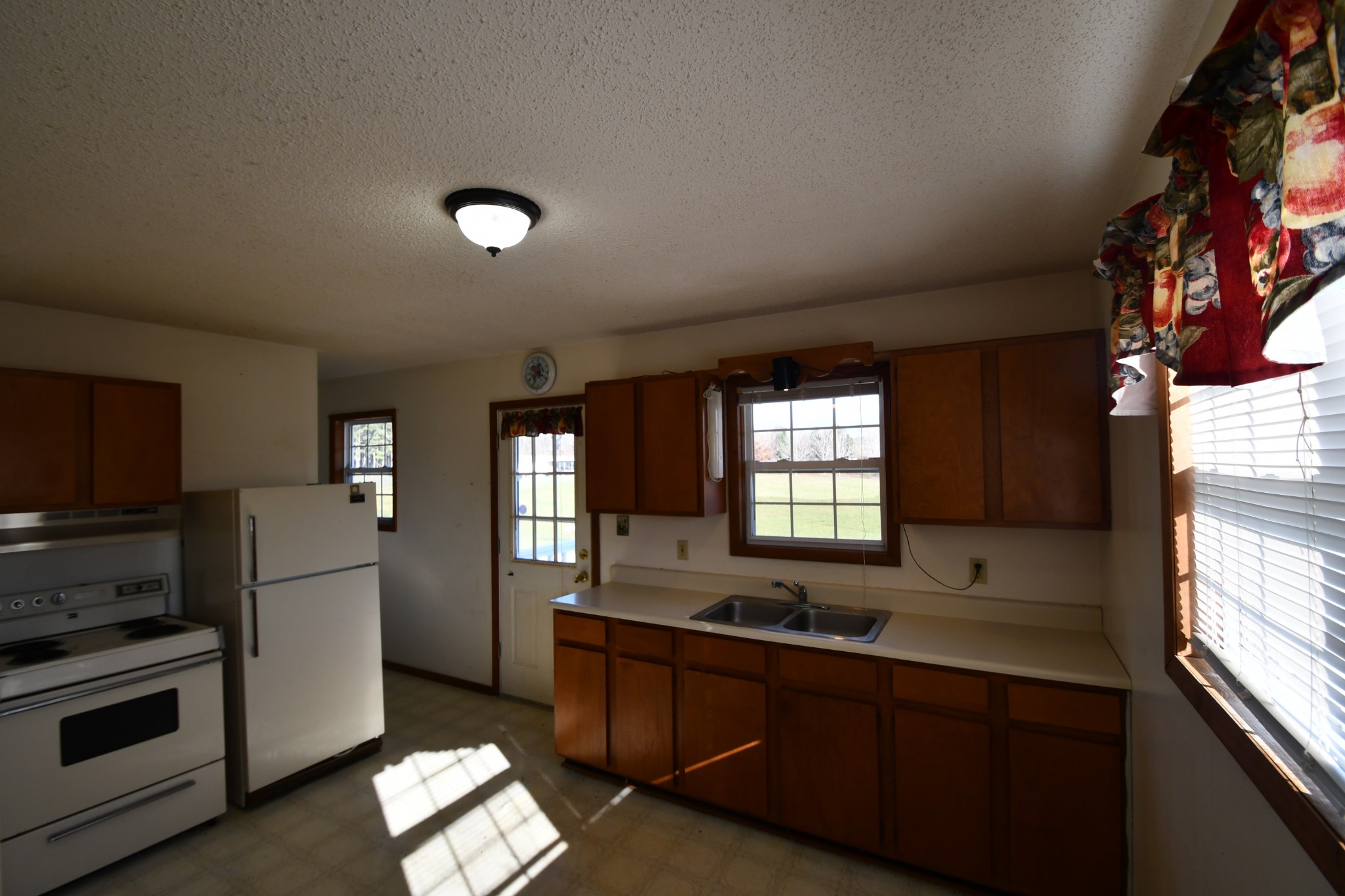 7 Fleeman Road Lawrenceburg, TN 38464 - Photo 11 of 16 a kitchen with stainless steel appliances granite countertop a sink a stove a refrigerator cabinets and a window