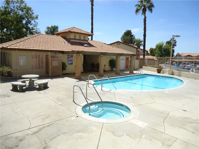 a view of a white house with pool table and chairs