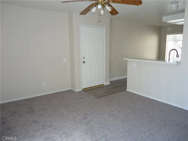 a view of a room with a ceiling fan
