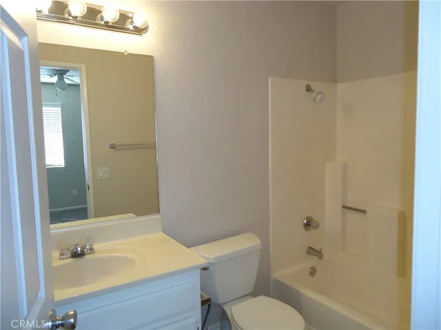 a bathroom with a sink mirror toilet and bathtub