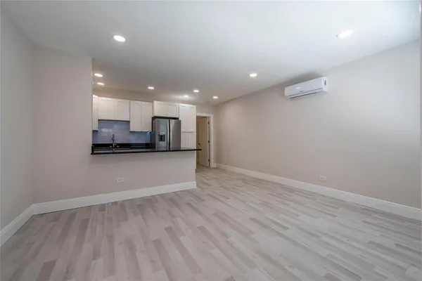 a view of kitchen with refrigerator and window