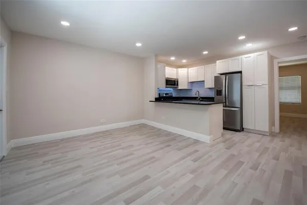 a view of kitchen with wooden floor