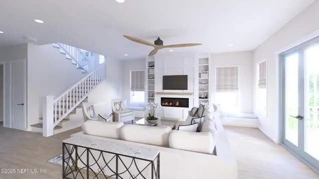 a living room with furniture a flat screen tv and a chandelier