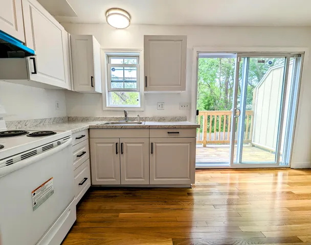 a kitchen with a sink window and cabinets