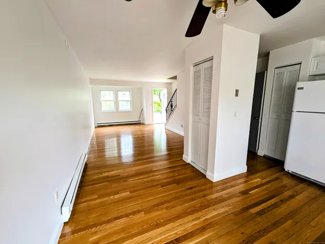 a view of a hallway view with wooden floor and staircase