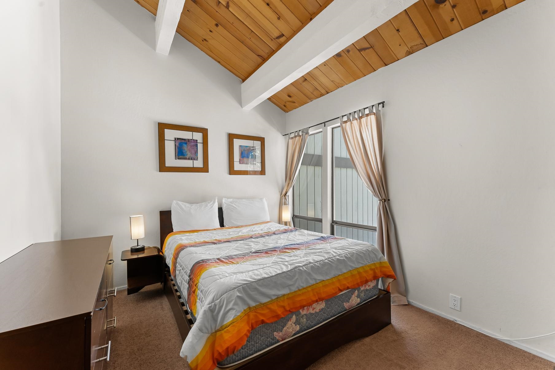 1001 Commonwealth Drive, Unit 101 Kings Beach, CA 96143 - Photo 11 of 28 a bed sitting in a bedroom next to a window