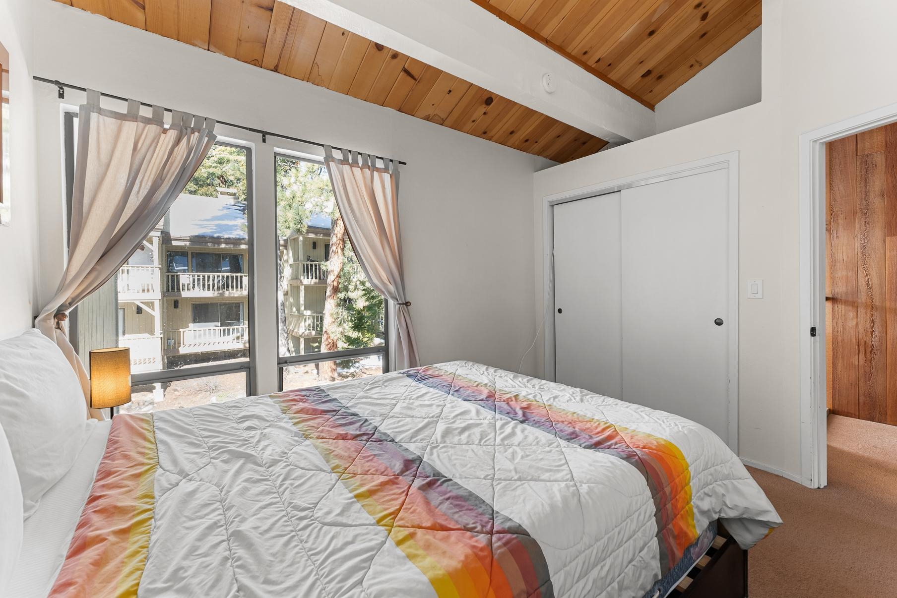 1001 Commonwealth Drive, Unit 101 Kings Beach, CA 96143 - Photo 12 of 28 a bedroom with a bed and a large window