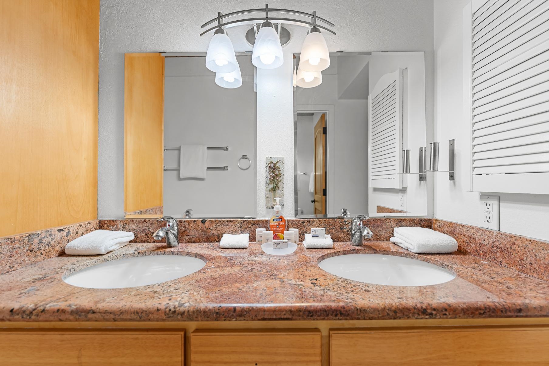 1001 Commonwealth Drive, Unit 101 Kings Beach, CA 96143 - Photo 14 of 28 a bathroom with a granite countertop sink and a mirror