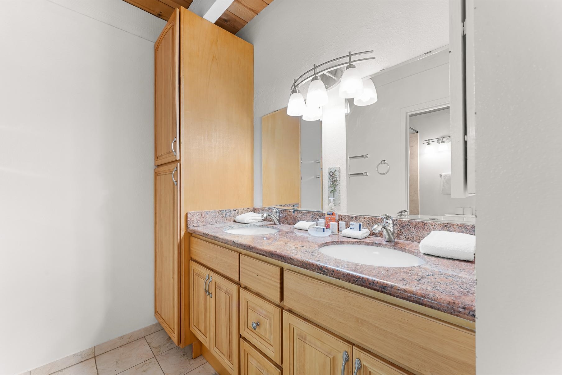 1001 Commonwealth Drive, Unit 101 Kings Beach, CA 96143 - Photo 15 of 28 a bathroom with a granite countertop sink and a mirror
