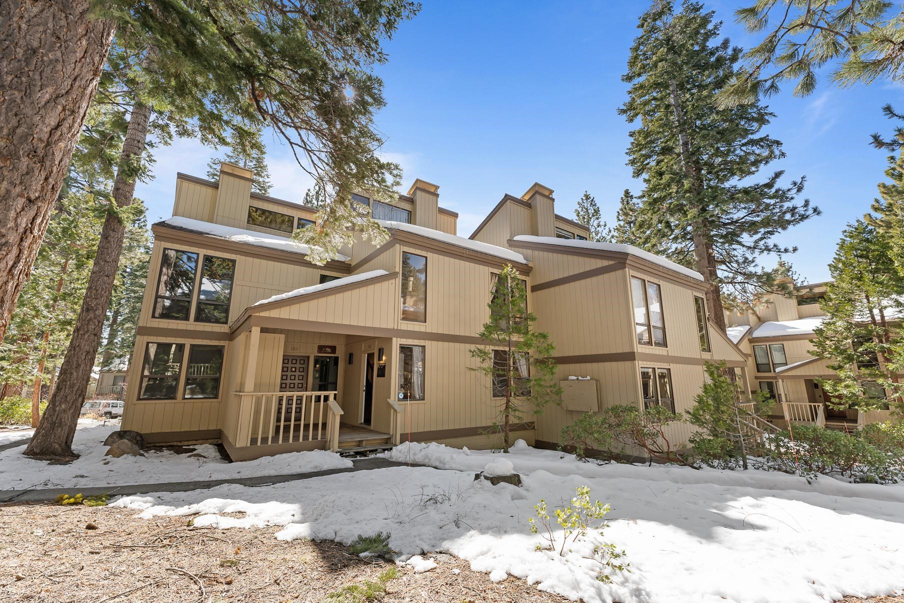 1001 Commonwealth Drive, Unit 101 Kings Beach, CA 96143 - Photo 22 of 28 a view of a white house with a large tree and wooden fence